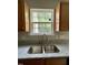Modern kitchen featuring granite countertops, a stainless steel sink, and a window with a view at 7832 Averette Field Dr, Raleigh, NC 27616