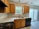 Modern kitchen featuring granite countertops and a stainless steel sink with a view at 7832 Averette Field Dr, Raleigh, NC 27616