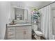 Bathroom featuring granite countertop vanity, toilet, shower, and towel storage rack at 784 Crawford Rd, Coats, NC 27521
