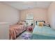 This is a cute bedroom with hardwood floors, and colorful furnishings at 784 Crawford Rd, Coats, NC 27521