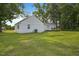 Exterior view of the home featuring a well-maintained yard and classic white siding at 784 Crawford Rd, Coats, NC 27521