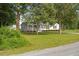 Charming single-story home with a cozy front porch and lush green lawn at 784 Crawford Rd, Coats, NC 27521
