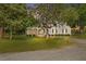 Quaint single-story home with a charming front porch and well-maintained lawn at 784 Crawford Rd, Coats, NC 27521
