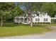 Charming single-story home with a cozy front porch, swing and lush green lawn at 784 Crawford Rd, Coats, NC 27521
