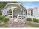 Inviting front porch features a swing, rocking chairs and decorative details at 784 Crawford Rd, Coats, NC 27521