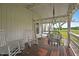 Relaxing front porch boasts rocking chairs, a porch swing, and string lights at 784 Crawford Rd, Coats, NC 27521