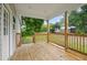Spacious back porch with natural wood flooring and railings, offering a relaxing outdoor space to enjoy the backyard view at 807 S Mebane St., Burlington, NC 27215