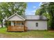 Cozy home exterior featuring a natural wood porch and railings, perfect for relaxing and enjoying the lush green backyard at 807 S Mebane St., Burlington, NC 27215