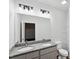 Bathroom featuring double vanity with granite counters, gray cabinets, and a large mirror with modern lighting at 807 S Mebane St., Burlington, NC 27215