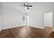 Spacious bedroom with wood-look flooring, ceiling fan, and natural light from a window overlooking the backyard at 807 S Mebane St., Burlington, NC 27215