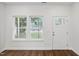 Bright entryway featuring hardwood floors, a white door, and ample natural light streaming through the windows at 807 S Mebane St., Burlington, NC 27215