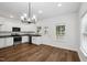 Bright kitchen featuring white cabinets, stainless appliances, granite countertops, and modern chandelier at 807 S Mebane St., Burlington, NC 27215