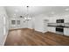 Open living space featuring hardwood floors, ceiling fan, kitchen, and dining area at 807 S Mebane St., Burlington, NC 27215
