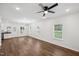 Bright and airy living space with hardwood floors, recessed lighting, and a view into the adjacent kitchen and backyard at 807 S Mebane St., Burlington, NC 27215