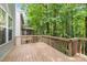 Wooden deck overlooks the backyard's lush greenery and mature trees, offering a serene outdoor space at 904 Pirouette Ct, Raleigh, NC 27606