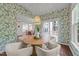 Charming dining room with a round table, stylish chairs, and natural light from many windows at 904 Pirouette Ct, Raleigh, NC 27606