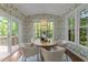 Charming dining room with a round table, stylish chairs, and natural light from many windows at 904 Pirouette Ct, Raleigh, NC 27606