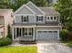 Charming two-story home with gray siding, covered porch, and well-manicured lawn at 904 Pirouette Ct, Raleigh, NC 27606