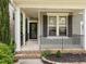 Welcoming covered front porch with black railings and brick trim at 904 Pirouette Ct, Raleigh, NC 27606