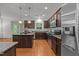 Modern kitchen featuring stainless steel appliances and granite countertops and wood floors at 904 Pirouette Ct, Raleigh, NC 27606