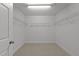 Empty walk-in closet with carpeted floors and shelving at 904 Pirouette Ct, Raleigh, NC 27606