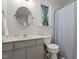 A full bathroom with a shower and tub combo, vanity, and a round mirror at 1 Old Towne Pl, Durham, NC 27713