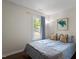 Bright bedroom with blue bedding, natural light, and hardwood floors at 1 Old Towne Pl, Durham, NC 27713