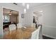Dining room features a wood table, chairs, modern lighting, and a view into the living room and kitchen at 1 Old Towne Pl, Durham, NC 27713