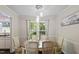 Dining room features a wood table, six chairs, modern lighting, and a view into the kitchen at 1 Old Towne Pl, Durham, NC 27713