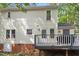 The back of the house with a deck and natural setting at 1 Old Towne Pl, Durham, NC 27713
