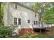 The back of the house with a deck and natural setting at 1 Old Towne Pl, Durham, NC 27713