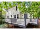 The back of the house with a deck and natural setting at 1 Old Towne Pl, Durham, NC 27713