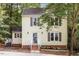 Charming two-story yellow home with a landscaped front yard and grey shutters at 1 Old Towne Pl, Durham, NC 27713