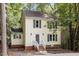 Charming yellow two-story home featuring a welcoming front porch, well-maintained lawn, and dark shutters at 1 Old Towne Pl, Durham, NC 27713