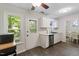 Bright eat-in kitchen with stainless steel appliances, white cabinets, and a door to outdoor space at 1 Old Towne Pl, Durham, NC 27713