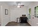 Well-lit kitchen space with hardwood floors, a microwave on a rolling cart, and a ceiling fan at 1 Old Towne Pl, Durham, NC 27713
