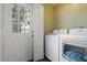 Bright laundry room with modern appliances and access to the backyard at 1 Old Towne Pl, Durham, NC 27713