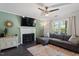 Cozy living room featuring a fireplace, ceiling fan, ample seating, and natural light at 1 Old Towne Pl, Durham, NC 27713