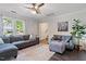 Comfortable living room with hardwood floors, a stylish sofa, and plenty of natural light at 1 Old Towne Pl, Durham, NC 27713
