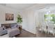 Open-concept design featuring hardwood floors, a sofa, and view into the dining area with table at 1 Old Towne Pl, Durham, NC 27713