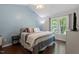 A calming main bedroom with a large window and hardwood floors providing natural light at 1 Old Towne Pl, Durham, NC 27713