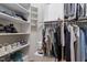 Organized walk-in closet with shelving and hanging rods for clothing and shoe storage at 1 Old Towne Pl, Durham, NC 27713