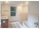 Bright bathroom with freestanding tub, double vanity, and tiled walk-in shower at 100 Eastwood Lake Rd Rd, Chapel Hill, NC 27514