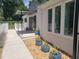 Exterior view of home with well-maintained landscaping, walkway and manicured planting beds at 100 Eastwood Lake Rd Rd, Chapel Hill, NC 27514
