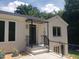 Charming home entrance featuring a covered porch, clean lines, and well-maintained landscaping at 100 Eastwood Lake Rd Rd, Chapel Hill, NC 27514