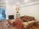 Bright living room with fireplace, hardwood floors, stylish furniture, and decorative accents at 100 Eastwood Lake Rd Rd, Chapel Hill, NC 27514