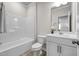 Pristine bathroom featuring a tub, toilet, and single sink vanity with modern fixtures at 1007 Sora Way, Durham, NC 27703