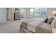 Bright bedroom with plush carpet, neutral walls, and a view of the en-suite bathroom at 1007 Sora Way, Durham, NC 27703