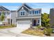 Charming two-story home with a two-car garage, landscaped front yard, and inviting curb appeal at 1007 Sora Way, Durham, NC 27703