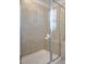 Modern tiled shower with a glass enclosure and bench seating inside the shower at 1007 Sora Way, Durham, NC 27703